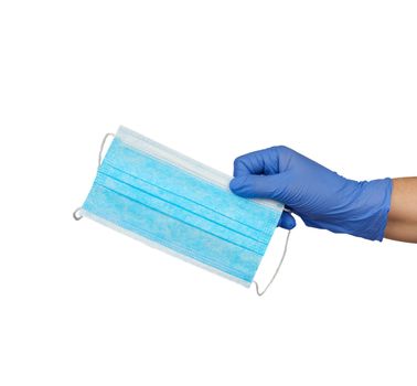 hand holds a medical face mask against viruses and bacteria on a white background, protective medical tool