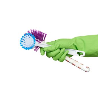white plastic cleaning brushes in hand, protective green glove on hand, white background