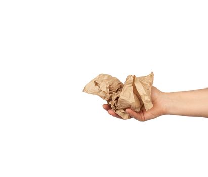 hand holds a crumpled brown sheet of parchment paper, subject is isolated on a white background