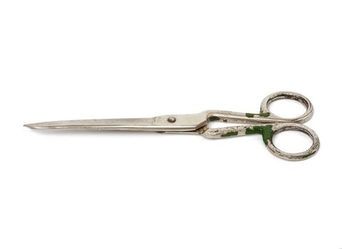 very old vintage metal tailor scissors isolated on a white background, close up