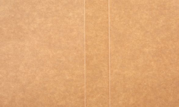 piece of smooth brown cardboard paper, full frame, close up