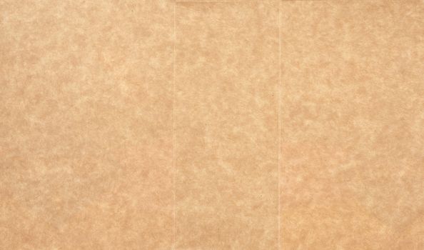 piece of smooth brown cardboard paper, full frame, close up