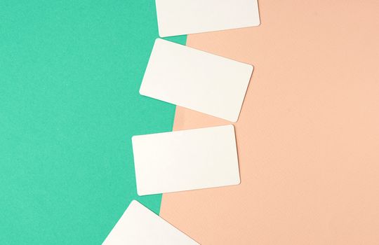 rectangular white blank business cards on a color background, backdrop for the designer