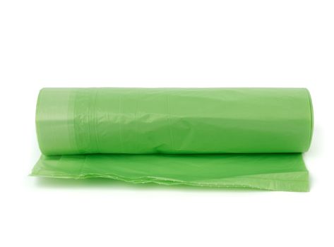 roll with green plastic transparent bin bags isolated on white background