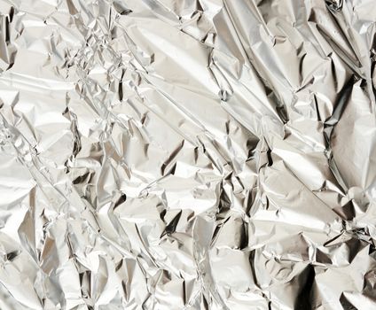 texture of matte crumpled piece of foil, food and objects packaging material, full frame