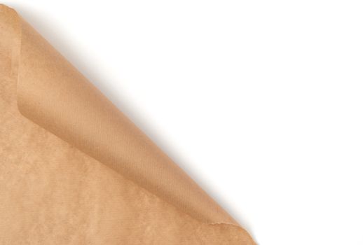 curved edge of a brown parchment paper sheet is isolated on a white background, place for an inscription