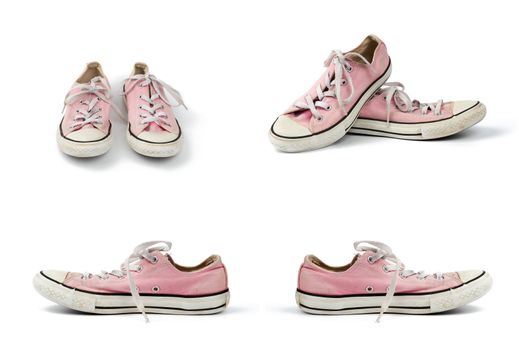 pair of light pink worn textile sneakers with laces isolated on a white background, front and side view, set