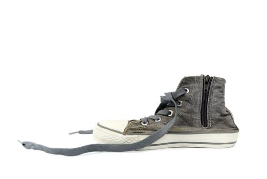 gray worn sneaker with textile untied laces isolated on a white background, walking shoes