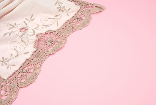 white kitchen textile towel folded on a pink background, copy space
