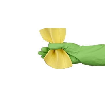 hand holds a yellow rag sponge for cleaning, protective green rubber glove is worn on the arm, close up