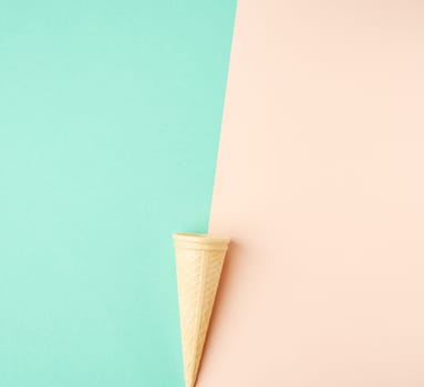 empty baked waffle cup on a colored background, top view
