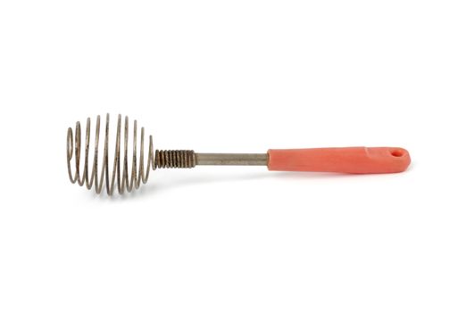 very old kitchen utensil for beating eggs, liquids with a handle isolated on a white background