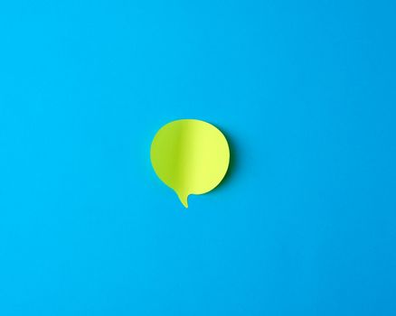 green empty paper sticker in the form of cloud on a blue background, copy space