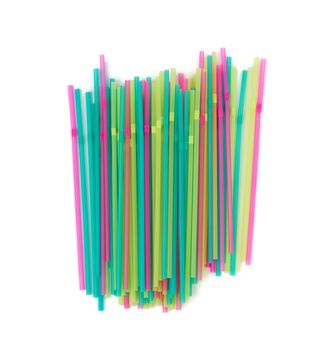 many multi-colored plastic tubes for cocktail isolated on white background, top view
