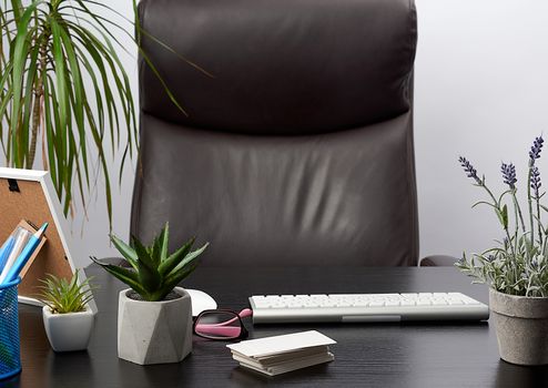 black table with stationery, wireless keyboard, mouse, workplace of a leader, businessman