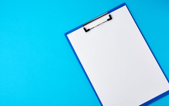 blue holder with clean white sheets on a blue background, copy space