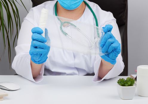 medic woman in white coat and mask holds a twisted gauze bandage for dressing wounds, white background