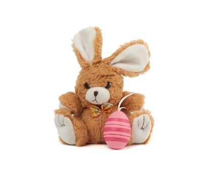 cute brown bunny and pink colored eggs on a white background, easter backdrop