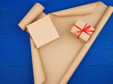 brown kraft paper, packed gift boxes and tied with a red ribbon, set of items for making gifts. Gift wrapping. Package design