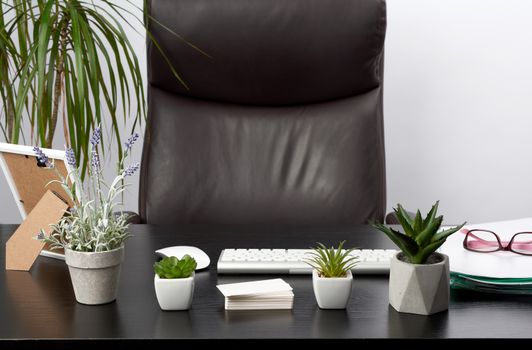 black table with stationery, wireless keyboard, mouse, workplace of a leader, businessman