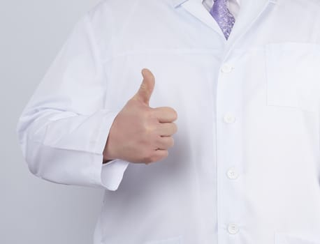 doctor in a white coat and tie shows with his hand a gesture like, white background, close up