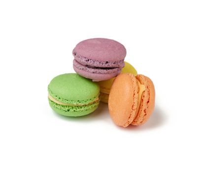 round baked multi-colored almond flour cakes macarons, dessert isolated on a white background, close up
