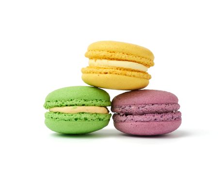 round baked multi-colored almond flour cakes macarons, dessert is stacked