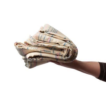 female hand holds folded cotton fabric, isolated white background, close up