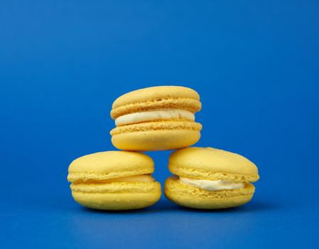 yellow lemon round baked macaroon cakes on a dark blue background, sweet dessert,  close up