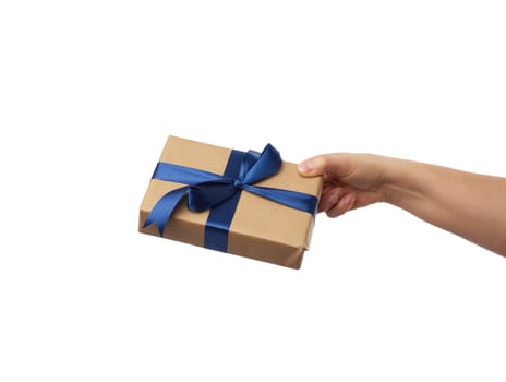 hand hold a wrapped gift in brown craft paper with tied silk blue bows, subject is isolated on a white background, concept of surprise and gift for the holiday