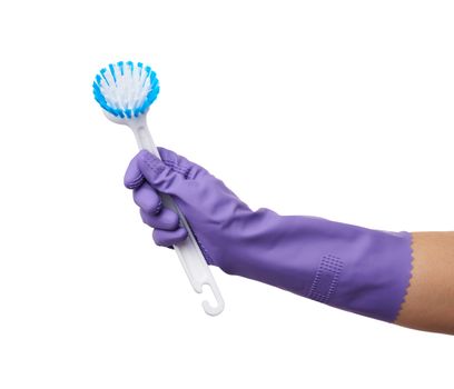 hand in purple rubber glove holds plastic brush for cleaning the house, part of the body is isolated on a white background