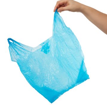 hand holds an empty blue plastic bag on a white background, concept of rejection of plastic and the transition to eco-packaging