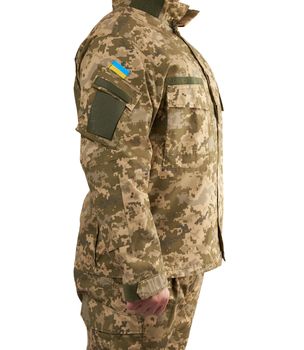 Ukrainian man warrior dressed in a military pixel uniform stands on a white isolated background, soldier stands sideways
