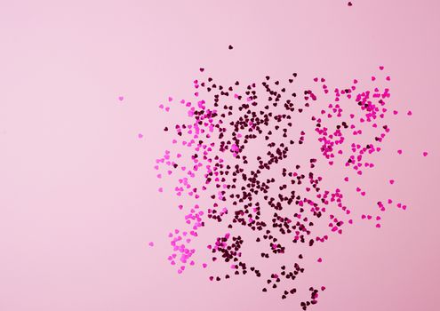 shiny pink confetti on a pink background, festive backdrop for birthday, valentines day. Festive decoration element. Flat design 