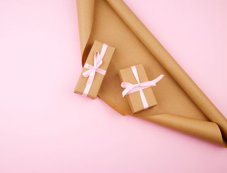 brown kraft paper, packed gift boxes and tied with a pink ribbon, set of items for making gifts. Package design, copy space