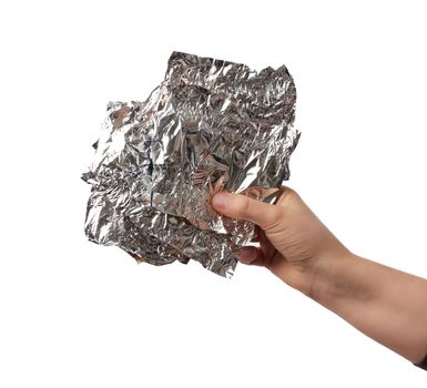 hand holds crumpled silver foil on a white isolated background, close up