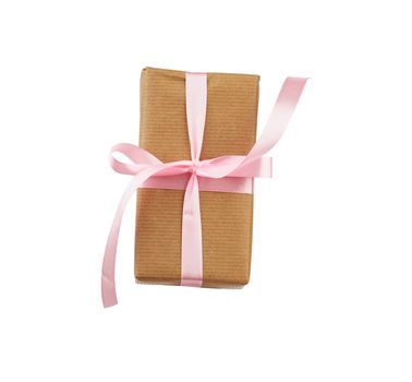 box wrapped in brown kraft paper and tied with a pink ribbon, gift isolated on a white background, element for a designer
