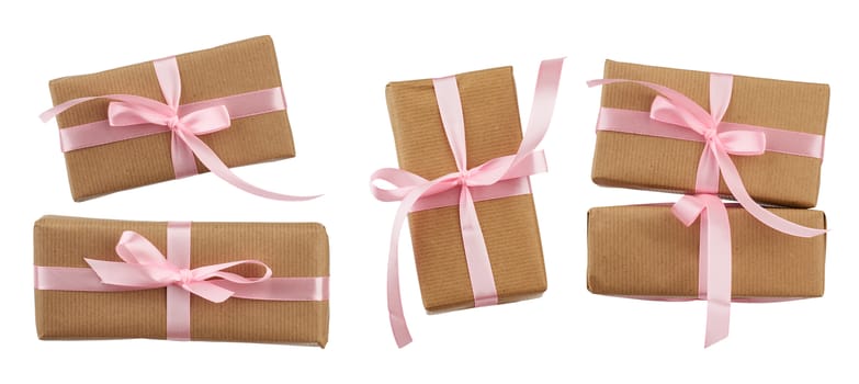 set of rectangular boxes wrapped in brown kraft paper and tied with a pink ribbon, gifts are isolated on a white background, element for a designer