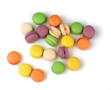 round baked multi-colored almond flour cakes macarons, dessert  isolated on a white background, top view