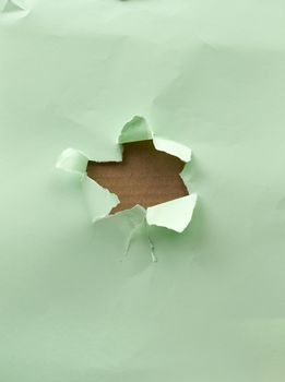 hole in green paper with torn and curved edges. Blank template.