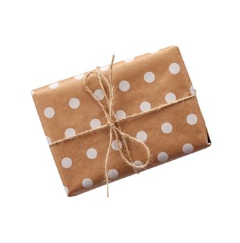 gift in box wrapped in brown kraft paper and tied with rope on a white background. Festive concept