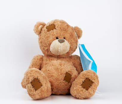 big teddy bear are sitting in white medical masks on a white background. Respiratory medicine.