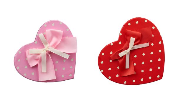 pink and red  heart-shaped cardboard box with bow isolated on white background, holiday gift wrapping