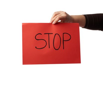 female hand holds a red sheet of paper with the inscription stop, do not panic concept