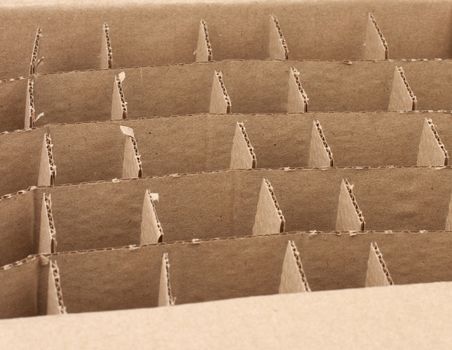 open empty cardboard box with partitions for transporting broken items of bottles and cans, close up