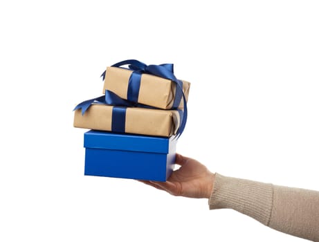 hand hold a wrapped gifts in brown craft paper with tied silk bows, subject is isolated on a white background, concept of surprise and gift for the holiday