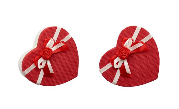 red heart-shaped cardboard box with bow isolated on white background, holiday gift wrapping