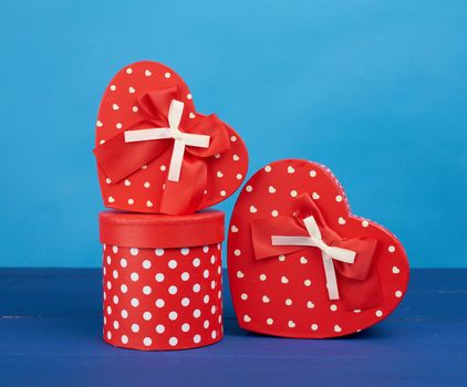 red cardboard boxes with gifts on a blue background, festive backdrop