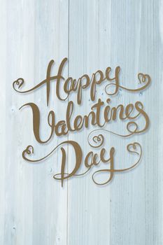 Happy valentines day against bleached wooden planks background