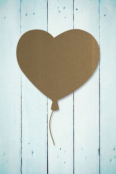 Heart balloon against painted blue wooden planks